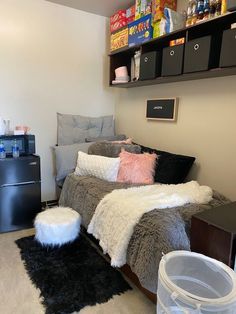 a room with a bed, black and white fur rugs and shelves on the wall