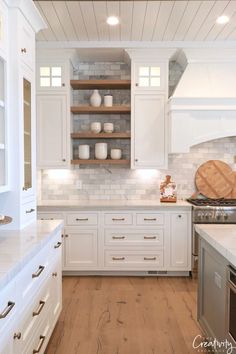 the kitchen is clean and ready for us to use it's white cabinetry