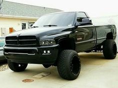 a black truck parked in front of a house