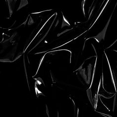 an abstract black and white photo with wavy lines in the dark, as if it were fabric