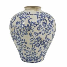 a blue and white vase with flowers on it