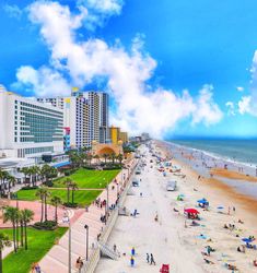 the beach is crowded with people and buildings