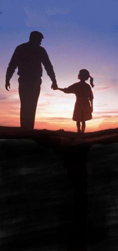 the silhouette of a father and daughter holding hands