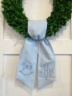 a wreath with a monogrammed horse on it