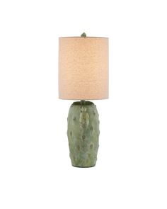 a green table lamp with a white shade on it's base and a beige linen lampshade