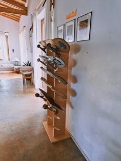 there is a skateboard rack in the middle of this room with pictures on the wall