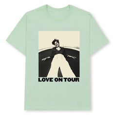 a green t - shirt with the words love on tour printed in black and white