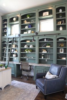 an office with green bookcases and blue chair