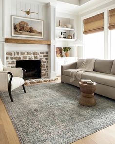 a living room filled with furniture and a fire place