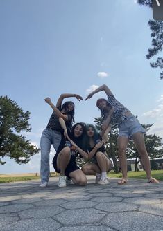 four young women posing for a photo in the park