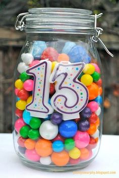 a glass jar filled with lots of colorful candies