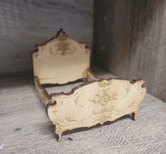 an old wooden bed frame sitting on top of a wood floor next to a wall