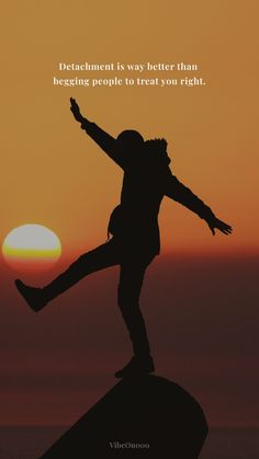 a person standing on top of a rock with the sun setting in the back ground