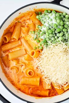 pasta, peas and cheese are in a skillet