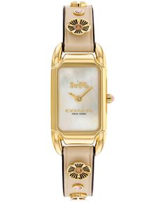 Inspired by the sleek designs of 1920s art deco, the Cadie watch has an elegant long and lean silhouette. Finished with an ivory leather strap featuring the COACH Signature and Tea Rose motif. Style #14504115.Movement - quartzCase - rectangular, gold-tone stainless steel, 17.5mm x 28.5mmStrap - ivory leather strap with tongue button buckleDial - color like mother of pearlWater resistant up to 30 meters2 year limited warranty Coach Watch, Horse And Carriage, Leather Strap Watch, 1920s Art Deco, Classy Jewelry, Tea Rose, Dream Jewelry