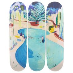 three skateboards with different designs on them, one is blue and the other is white