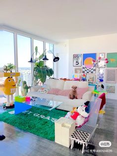 a living room filled with lots of furniture and large windows overlooking the cityscape