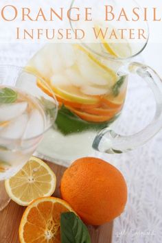 orange basil infused water in pitcher and sliced oranges