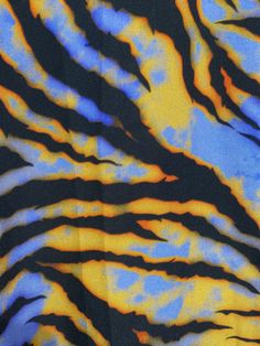 an animal print fabric with blue, yellow and black stripes