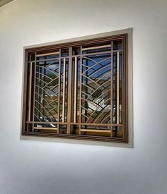 a window that is on the side of a wall in a room with white walls