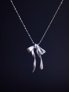 This Sterling Silver Bow Necklace is a dainty, handmade piece crafted from 925 Sterling Silver. With its elegant ribbon design, it's the perfect minimalist everyday necklace or a thoughtful gift for her. ☘️ Necklace length: 16 inches ☘️ Other Considerations: - Comfort Assured: My handmade jewelry is nickel-free and hypoallergenic, making it safe and comfortable for all skin types. - Worry-Free Returns: If you're not satisfied for any reason, I offer a 14-day return policy, and you can keep the j Silver Necklace Simple, Thoughtful Gifts For Her, Ribbon Necklace, Bow Necklace, Silver Bow, Ribbon Design, Everyday Necklace, Wedding Jewellery Necklace, Necklace Dainty