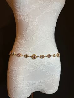 High quality metal chain & Jewel Stone belt.  Beautiful Pink and Silver Jewel on a gold metal base set off this belt.  Exclusively designed by FAN Design, this belt is made to a wide range of sizes. Matching necklace also available. Hand crafted to sizes.   Choose your waist size in inches, all belts will come with an extra 12 inch hanging chain Tap into the hottest new trend with chain belts! This chic piece of bodywear can be draped over your clothing to enhance your outfit or worn with bare midriff looks. Pair it with a simple black ensemble for an elegant finish. Perfect accessory for a wide range of outfits. Gold Chain Strap Jewelry For Wedding, Elegant Gold Metal Waist Chain, Elegant Gold Waist Chain For Wedding, Gold Rhinestone Chain Belt For Party, Gold Chain Belt With Rhinestones For Party, Gold Waist Chain, Elegant Swimwear, Gold Chain Belt, Belt Chain