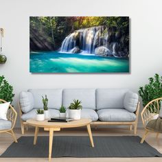 a living room filled with furniture and a painting on the wall above it's water fall