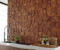 a wooden wall in a kitchen next to a sink and counter with bottles on it