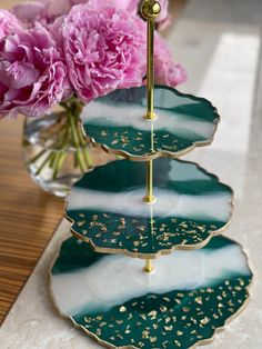 three tiered trays with flowers in the background