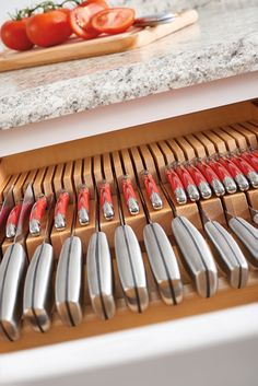 knives are lined up on a cutting board