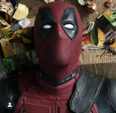 a deadpool is sitting next to some food