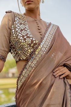 Bronze mirror embroidered hem saree. Paired with a potli button padded blouse and a mirror embroidered jacket. - Aza Fashions Traditional Drape Blouse With Mirror Work In Tissue Silk, Wedding Blouse With Mirror Work In Cotton Silk, Transitional Gota Work Blouse Piece, Tissue Silk Blouse With Mirror Work For Reception, Festive Tissue Silk Blouse With Mirror Work, Festival Cotton Silk Blouse Piece With Mirror Work, Designer Cotton Silk Blouse With Gota Work, Semi-stitched Cotton Silk Blouse With Mirror Work, Festive Cotton Silk Blouse With Mirror Work