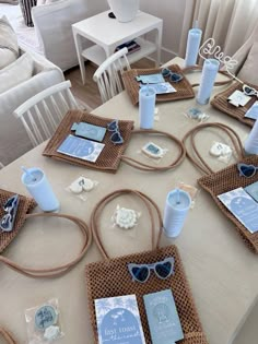 the table is set with blue and white items for an ocean themed party or baby shower