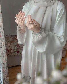 a woman in a nun outfit holding her hands together