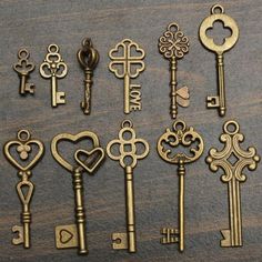 there are many different keys on the table together, including one with heart and keyholes