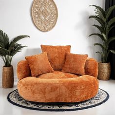 a living room filled with furniture and potted plants