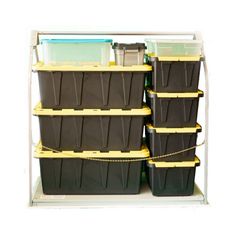 several plastic storage bins are stacked on top of each other with yellow handles and black lids