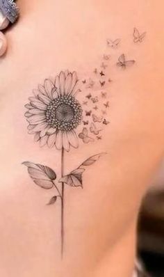 a woman's stomach with a tattoo on it and a flower in the middle