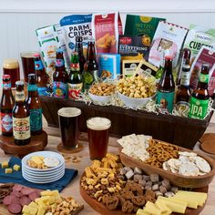 a wooden table topped with lots of different types of food and drinks on top of it