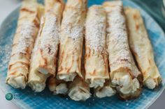 some food is sitting on a blue and white plate with powdered sugar in it