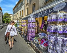 a woman is walking down the street in front of a store