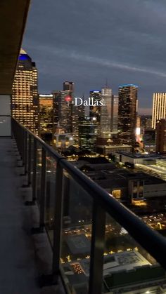 the city skyline is lit up at night, with tall buildings and skyscrapers in the background