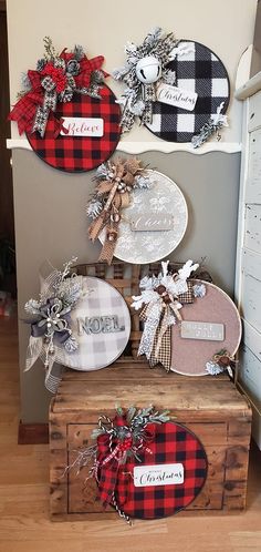 three wooden boxes are stacked on top of each other and decorated with plaid ribbon bows