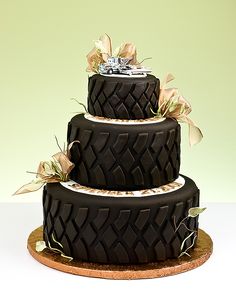 a three tiered chocolate cake with flowers on top