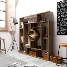 a living room filled with lots of furniture next to a wall mounted book shelf and window