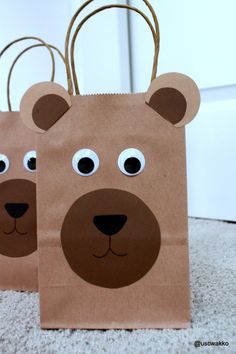 two brown paper bags with eyes and ears on the front one has a bear's head