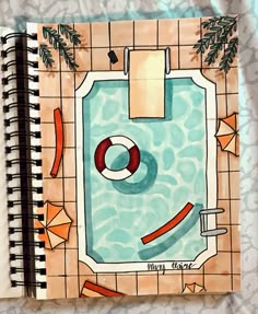 an open notebook with a drawing of a swimming pool and life preserver on it