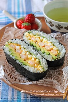 sushi with avocado and strawberries on the side