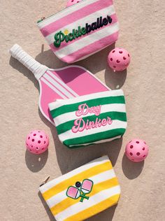 pink, green and white striped bag next to other items on the ground with polka dot balls