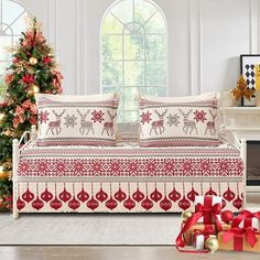 a living room decorated for christmas with presents on the floor and trees in the background